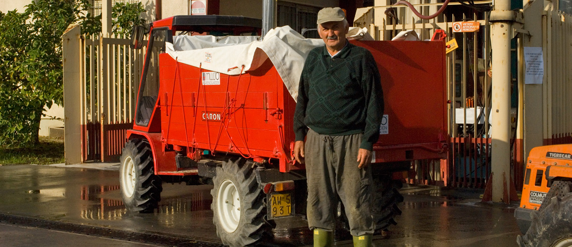 Vine worker and red tractor